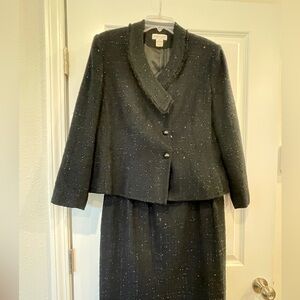 Black 2 piece long sleeved evening suit with fringed collar.